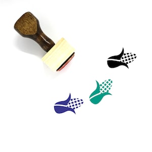 May include: A wooden stamp with a handle and a rectangular base. The stamp has a design of a corn cob with husks. The design is shown in black, green, and purple.