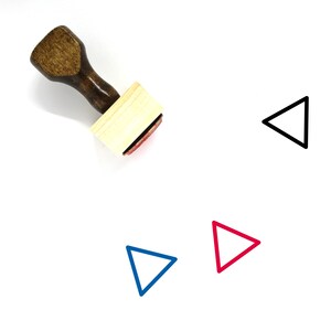 May include: A wooden stamp with a handle and a square base. The stamp is used to create a triangle shape. The image shows the stamp and three different colored triangles: black, blue, and red.