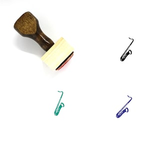 May include: A wooden rubber stamp with a black ink pad. The stamp features a silhouette of a saxophone in black, green, and blue.
