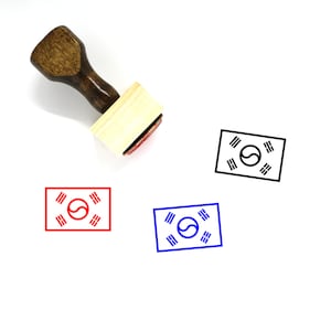 May include: A wooden stamp with a red, blue, and black ink pad. The stamp features the South Korean flag with a white circle and four black lines.
