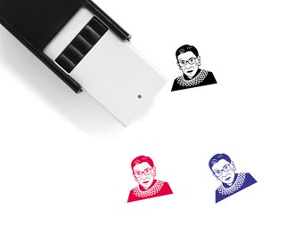 May include: A black and white image of a woman wearing glasses and a collar. The image is printed on a white rubber stamp. The stamp is also available in red and blue.