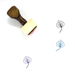 May include: Wooden stamp with a brown handle and a square wooden base. The stamp features a black outline of a leaf with veins.