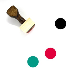 May include: A wooden stamp with a black, red, and green circle design. The stamp is on a white background.