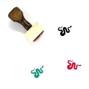 May include: Wooden rubber stamp with a snake design. The stamp is brown with a light wood block. The snake design is shown in black, green, and red.