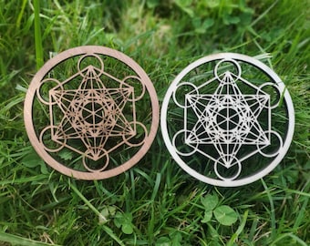 May include: Two wooden coasters with a geometric design. One coaster is brown and the other is white.