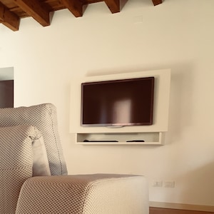 Wall-mounted TV cabinet with sound bar arrangement and cable passage