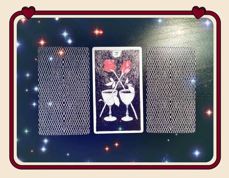 May include: Three rectangular tarot cards arranged horizontally. The center card features a black and white illustration of two chalices with two red roses crossed above them, labeled with the Roman numeral II. The two outer cards show a white grid pattern.
