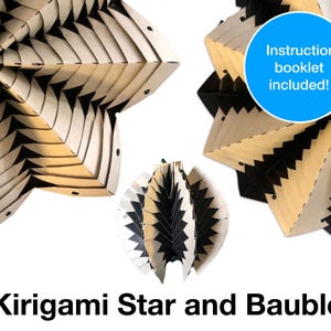 May include: A black and white geometric kirigami star and bauble, both made of paper. The star is flat and the bauble is 3D. The image includes the text "Instruction booklet included!" and "Kirigami Star and Bauble".
