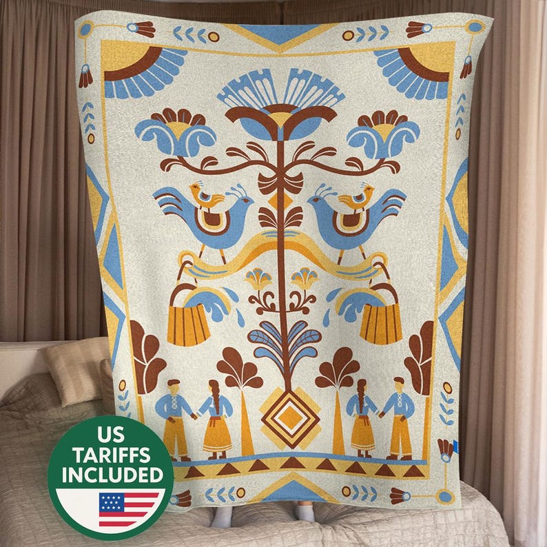 May include: A cream-colored blanket with a folk art design. The design features blue birds, flowers, and figures in yellow, blue, and brown. The blanket has a geometric border and the text "US TARIFFS INCLUDED" with a US flag.