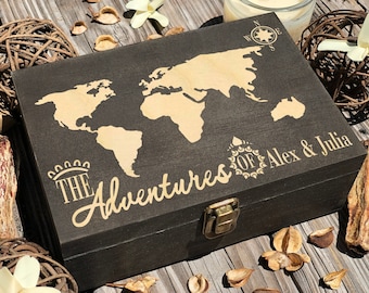 May include: A dark brown wooden box with a gold world map design and the text "The Adventures of Alex & Julia".