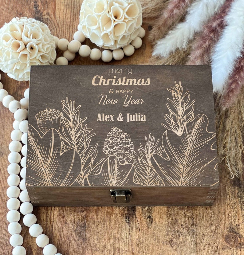 May include: A wooden box with a hinged lid and a latch. The box is decorated with a floral design and the text "merry Christmas & happy New Year Alex & Julia".