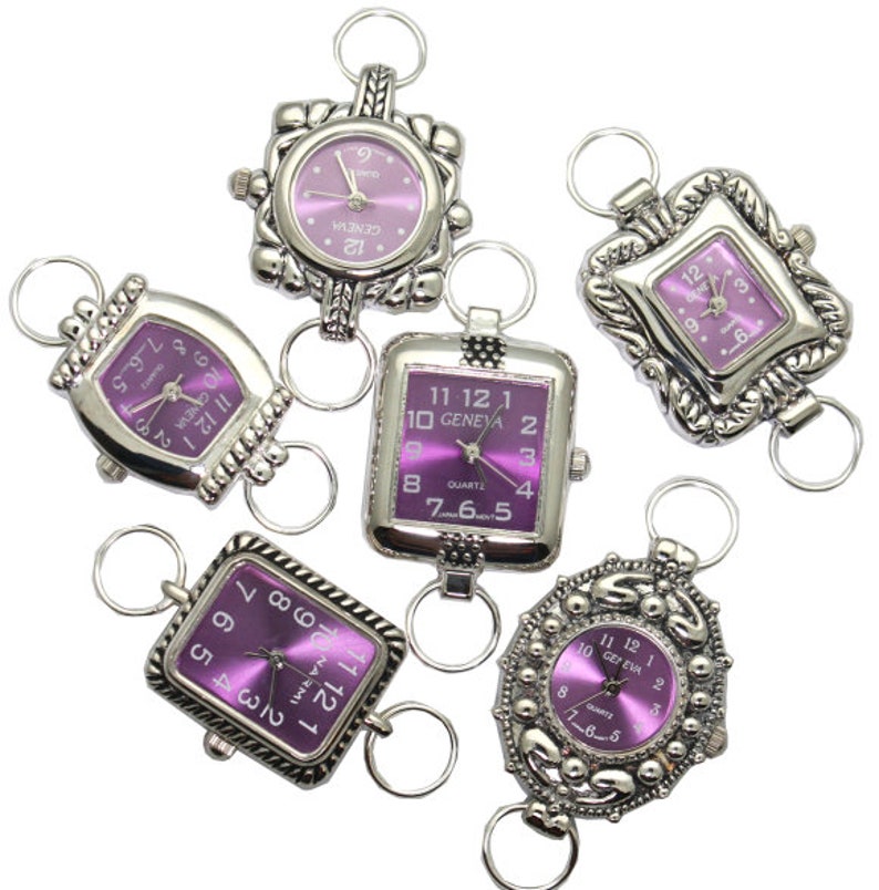 May include: Six silver-toned watch charms with purple faces. The watch faces have Roman numeral markings and the words "GENEVA" and "QUARTZ".