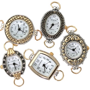 May include: Five silver and gold tone watch charms with white faces and black numbers. The watches have different shapes and designs, including round, oval, and rectangular.