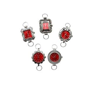 May include: Five silver-tone wristwatches with red faces. The watches have different styles of cases and bands. The watches are all set to different times.