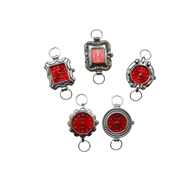 May include: Five silver-tone wristwatches with red faces. The watches have different styles of cases and bands. The watches are all set to different times.