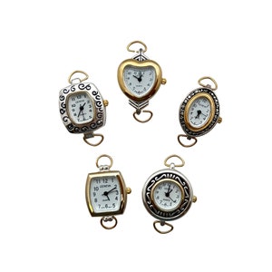 May include: Five silver and gold tone wristwatches with different face shapes and designs. The watches have white faces with black numbers and hands. The watches are attached to a gold tone chain.