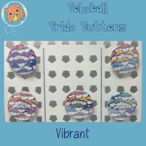 May include: Five circular buttons featuring a repeating pattern of small Pokeballs in various color palettes. The buttons are arranged on a white display card with a pentagonal cutout pattern. Text at the top reads Pokeball Pride Buttons.