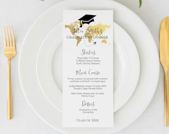 May include: A white card with black text and a gold foil world map design. The card is a graduation dinner menu with the name "Julia South's" and the text "Graduation Dinner". The menu includes starters, main course, dessert, and the text "Class of 202x".