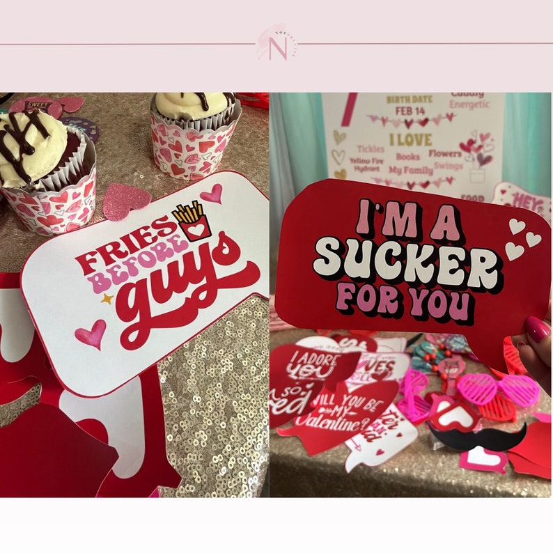 May include: A set of Valentine's Day photo booth props with red, pink, and white hearts. The props include a speech bubble that says "I'm a sucker for you", a speech bubble that says "Fries before guys", and a pair of pink sunglasses.