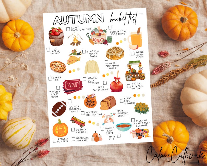May include: A white paper with an "Autumn Bucket List" printed in black. The list includes illustrations of fall activities like apple picking, baking pie, and carving pumpkins. The image is surrounded by pumpkins and fall foliage.
