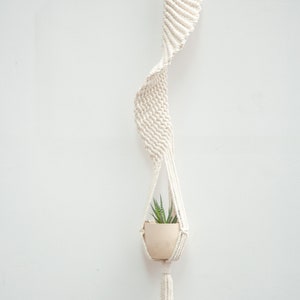 Minimalist style macrame plant hanger in Style B without beads, showcasing a clean white design measuring 100cm long, holding a small potted succulent, perfect for modern home decor.