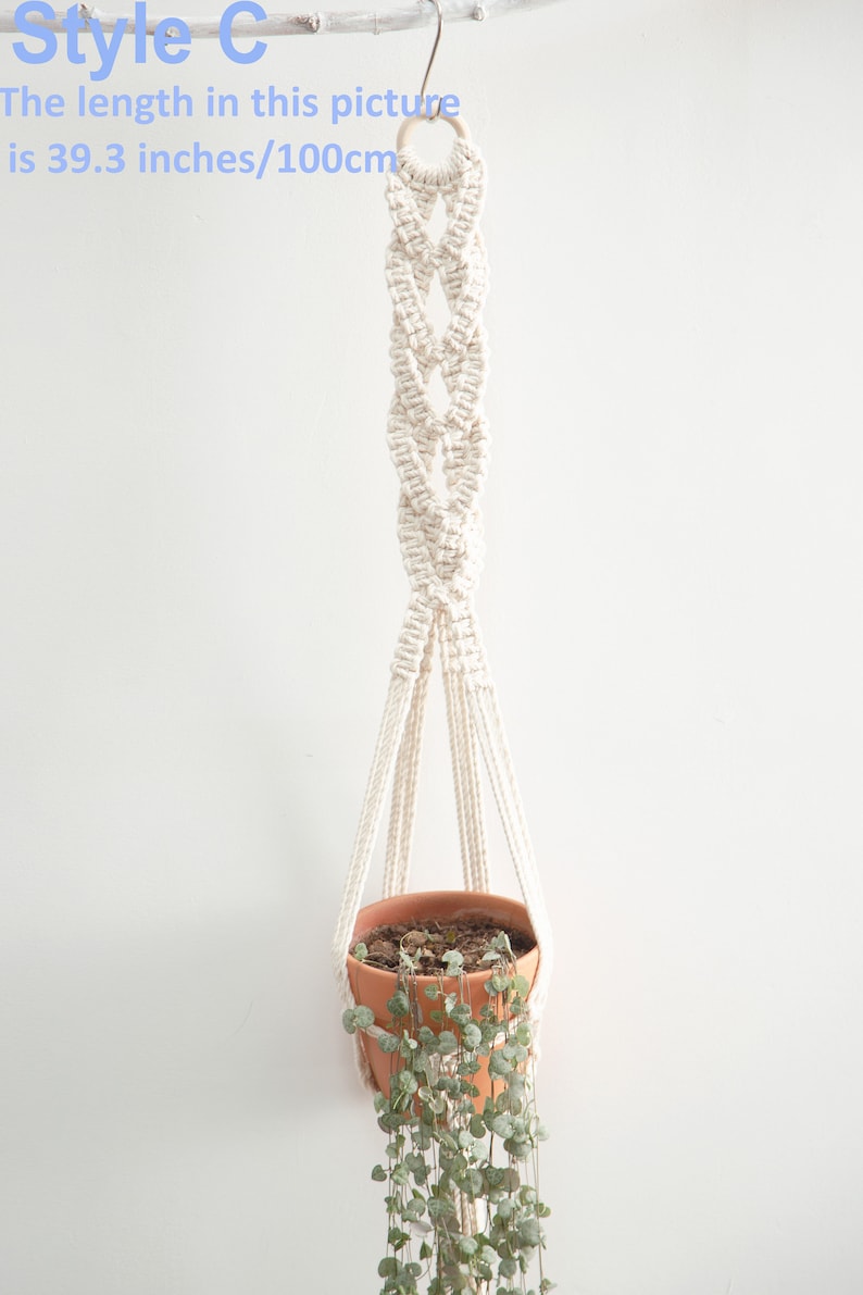 Stylish Style C macrame plant hanger measuring 100 cm in length, crafted from white cotton rope with intricate knotting, suspending a terracotta pot with trailing greenery for a modern home decor accent.