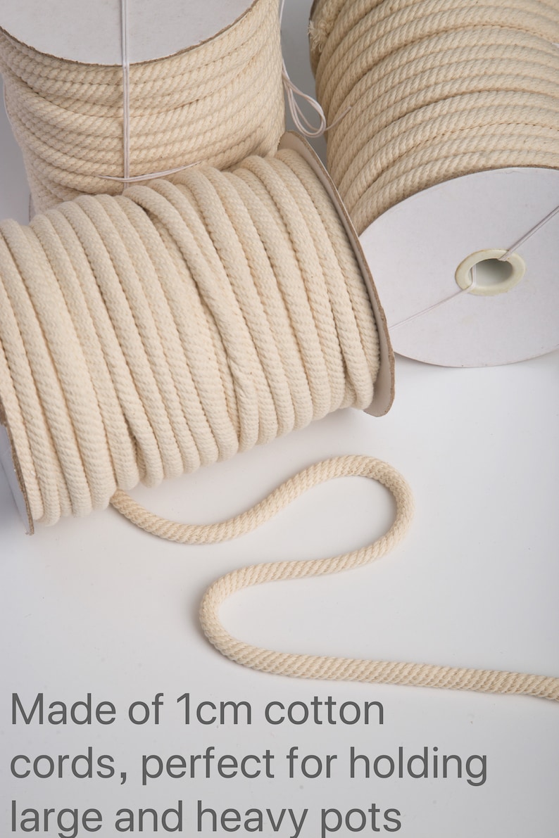 May include: Three spools of natural cotton rope, each 1 cm thick. The rope is wound around cardboard spools. The rope is made of natural cotton and is perfect for hanging plants or other heavy objects.