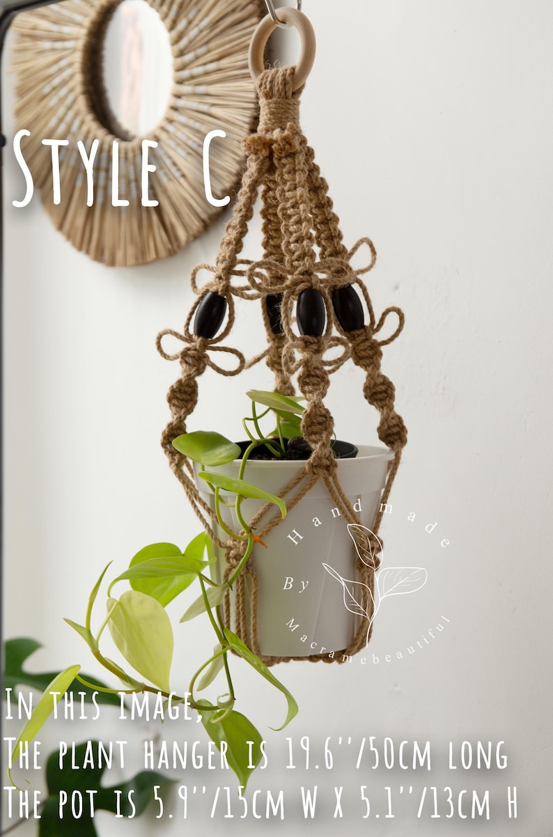 Handcrafted jute macramé plant hanger (Style C) with carved wooden beads and bow knots suspending a white 5.9″×5.1″ pot of trailing philodendron—boho indoor hanging planter, 19.6″/50 cm length.