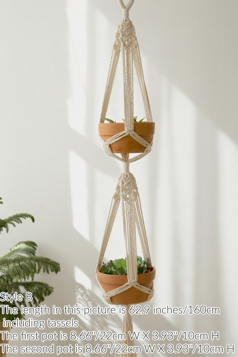 Artisanal macrame plant hanger in style B featuring intricate knotwork and tassels, displaying two terracotta pots with lush greenery, highlighted by natural light and shadows.