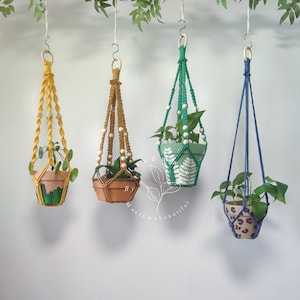 Vibrant collection of macrame plant hangers in yellow, Cinnamon, Green, and Navy blue, created by Macramebeautiful, each adorned with wooden beads, adding a pop of color to interior spaces