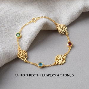May include: Gold chain bracelet with three birth flower charms and colorful gemstones.  Up to 3 birth flowers & stones.