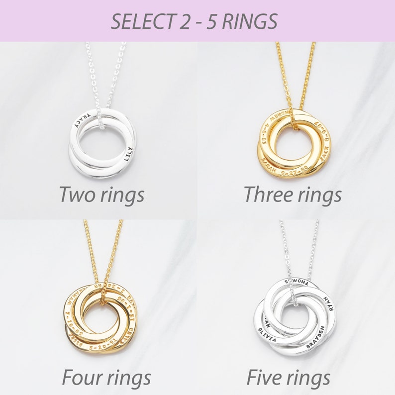 May include: A selection of personalised ring necklaces in silver and gold. The image displays options with two to five rings, each engraved with names and dates. The text at the top reads "SELECT 2-5 RINGS".