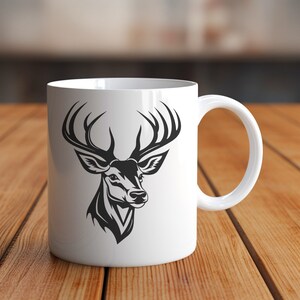 May include: White ceramic mug with a black silhouette of a deer head with antlers.