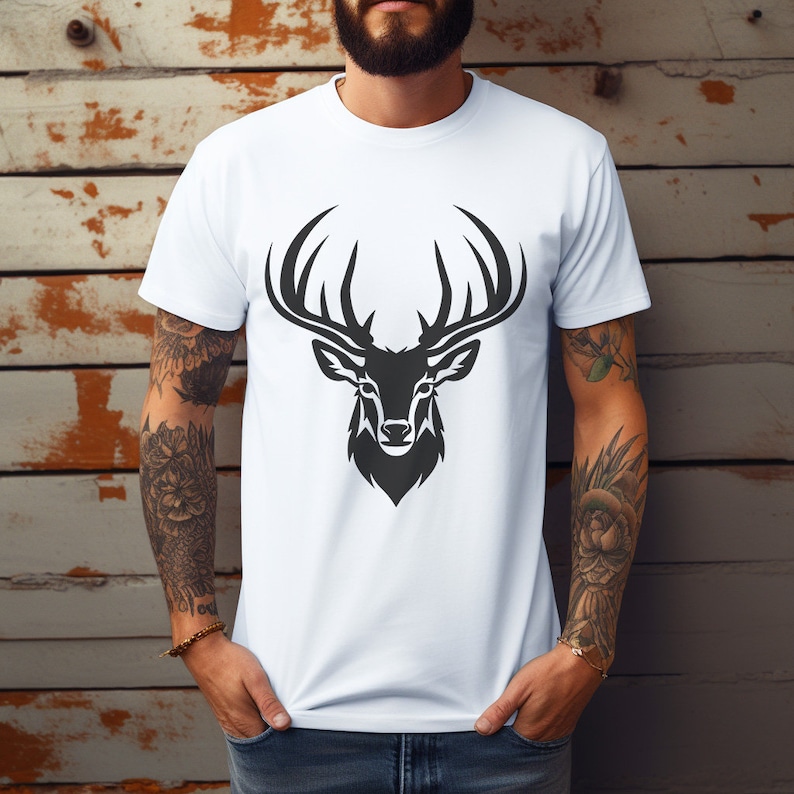 May include: A white t-shirt with a black silhouette of a deer head with antlers.