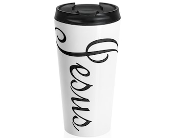 May include: White travel mug with a black lid and a black cursive design that says "Jesus" with a treble clef.
