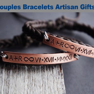 May include: Two matching copper bracelets with black cord. The bracelets have engraved roman numerals and the infinity symbol. The text on the bracelets reads "A+ROOVI-XVII-MMXXII" and "A+ROOVI-XVII-MMX".