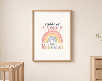 May include: A framed wall art print featuring a pastel-coloured rainbow graphic with the text Made of Love and Rainbows in a script and sans-serif font, accented by small pink hearts, displayed in a light wood frame on a neutral wall.