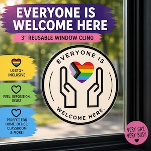May include: A circular window cling with a cream background, black text reading EVERYONE IS WELCOME HERE, and a central graphic of two black-outlined hands cradling a multi-coloured pride heart. The text 3" REUSABLE WINDOW CLING is visible.