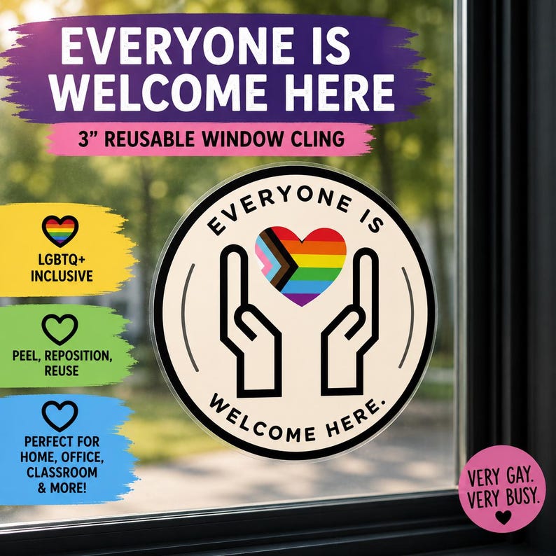 May include: A circular window cling with a cream background, black text reading EVERYONE IS WELCOME HERE, and a central graphic of two black-outlined hands cradling a multi-coloured pride heart. The text 3" REUSABLE WINDOW CLING is visible.