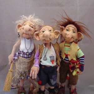 May include: Three handmade dolls with whimsical features. The dolls are dressed in colorful clothing and have unique hairstyles. The doll on the left is holding a broom, the doll in the middle is wearing a blue shirt and jeans, and the doll on the right is wearing a yellow vest and holding a bouquet of flowers. All Rights Reserved! ©2009 Ute Visina