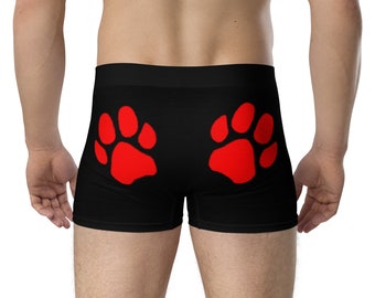 May include: Black boxer shorts with red paw prints on the back.