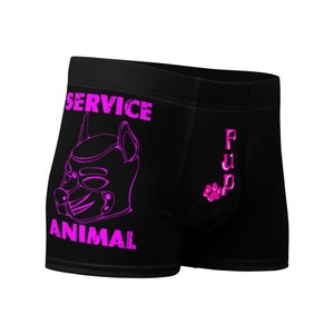 May include: Black boxer briefs with a pink graphic of a dog's face and the words "SERVICE ANIMAL" on the front. The back features the word "Pup" and a paw print in pink.