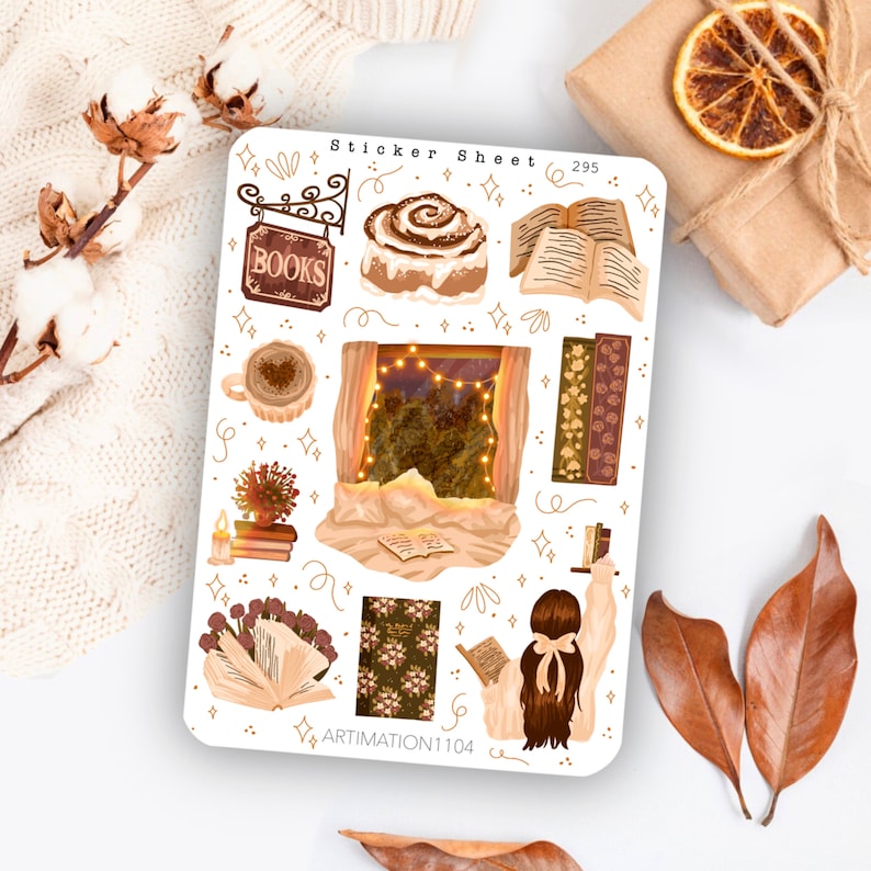 May include: A sticker sheet with a cosy autumn theme featuring illustrations of books, a cinnamon roll, a window with lights, a cup of coffee, and a person reading a book. The sheet is white with gold accents and the text "Sticker Sheet 295" and "ARTIMATION1104".