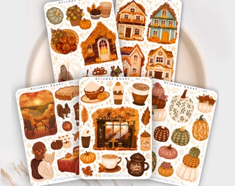 May include: Four sticker sheets with a fall theme. The sheets feature illustrations of houses, coffee shops, pumpkins, squirrels, and fall foliage in warm colors like orange, brown, and yellow.