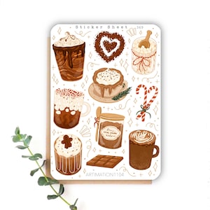 Può includere: Un foglio di adesivi con una varietà di illustrazioni di cioccolata calda, cacao in polvere, marshmallow e bastoncini di zucchero. Il foglio è bianco con accenti dorati e il testo "Sticker Sheet 369" e "ARTIMATION1104".