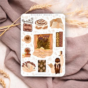May include: A sticker sheet with a cosy autumn theme. It features illustrations of a cinnamon roll, a window with lights, a book, a cup of coffee, a bookshelf, and a person reading a book. The sticker sheet is labelled "Sticker Sheet 295" and "ARTIMATION1104".