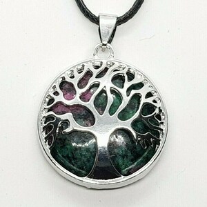 May include: Silver tree of life pendant with a green and pink gemstone inlay.