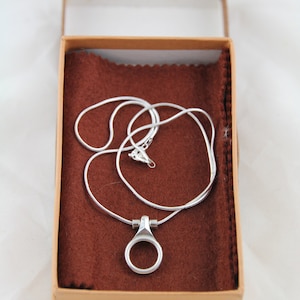 Silver necklace with clarinet key pendant