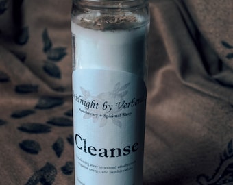 May include: A white candle in a clear glass jar with a label that reads "Midnight by Verbena Apothecary + Spiritual Shop" and "Cleanse" with the text "For clearing away unwanted attachments, negative energy, and psychic debris" and "Intention Candle | 8.1 oz (230 g) Prepared in Long Beach, MS".