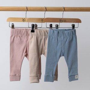 rolled hem leggings in various colours hanging from Aneby clothes hangers